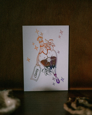 A white art print featuring a stylized illustration of a potion bottle with a label reading 'Clarity' and small stars, displayed against a dark brown textured background.