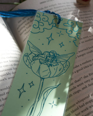 Decorative bookmark with fairy design on an open book