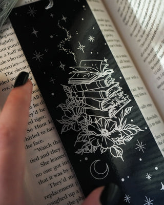 Black bookmark with silver foil book design on an open book