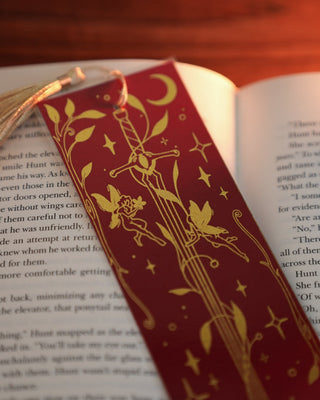 Open book with a decorative red and gold bookmark in a book.