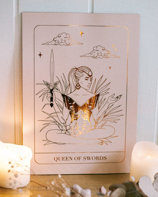Framed tarot card titled 'Queen of Swords' with bronze foil.