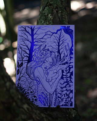A rectangular art print featuring a detailed illustration of a fairy hugging a deer nestled among trees and foliage, displayed against a dark, blurred forest background.