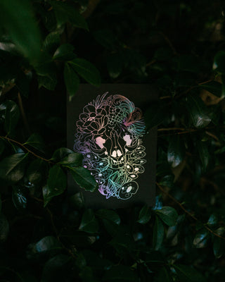 Colorful skull design on a dark card with a natural background
